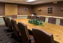 Meeting room with a large table and surrounded by chairs