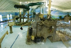Waterpark Overview with many things to climb on, basketball hoops, a large slide, and more