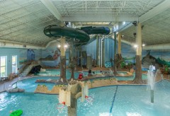 Waterpark Overview with many things to climb on, basketball hoops, a large slide, and more
