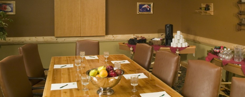Meeting room with large table surrounded by chairs and a coffee bar